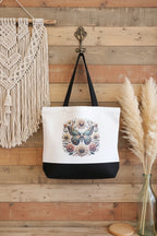 Sac réutilisable blanc et noir avec illustration colorée de papillon et fleurs.