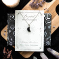 Collier lune d'obsidienne sur carte de vœux